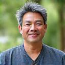 Portrait of a serene mindfulness specialist, Dr. David Lee.